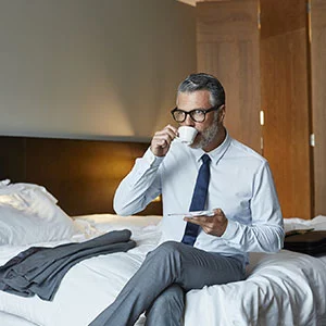 Person drinking coffee from a mug in a relaxed setting