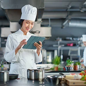 Person standing in a modern kitchen, preparing food on the countertop
