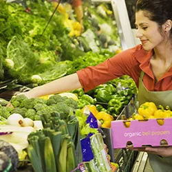 Person browsing items in a grocery store aisle