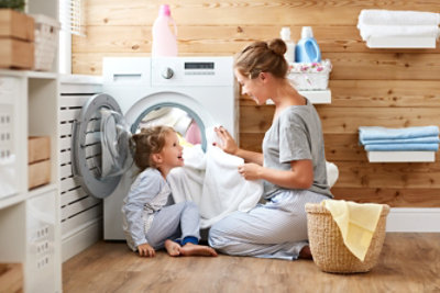 mom and daughter doing laundry