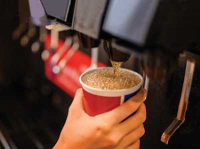 Hand Holding Cup at Soda Fountain